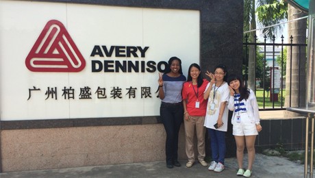 Group of women in front of Avery Dennison logo